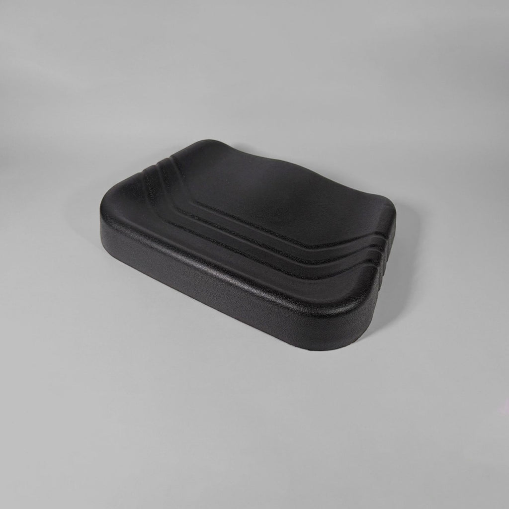A black molded seat cushion with a contoured, wavy top surface and ribbed side edges, shown on a neutral gray studio background.